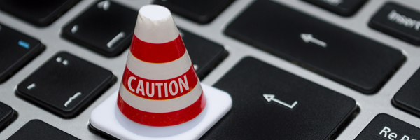 caution cone over a computer keyboard